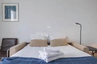 a bedroom with a bed with towels on it at Palais Miramar - Suite & G17 - Vue Mer - Croisette Emplacement Unique -20 Plage - WIFI - Clim in Cannes