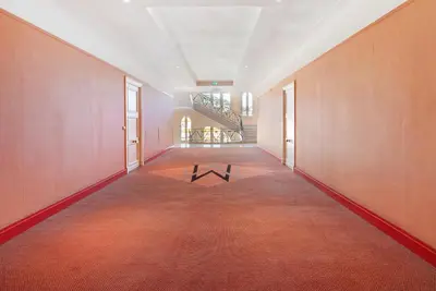 a hallway with a table in the middle of a room at Palais Miramar - Suite & G17 - Vue Mer - Croisette Emplacement Unique -20 Plage - WIFI - Clim in Cannes