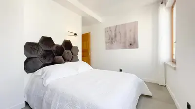 a bedroom with a white bed in a white room at Le Riviera by Winsome Destination in Cannes