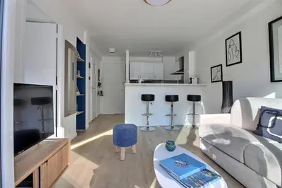 a living room with a couch and a table at CENTRAL CANNES in Cannes