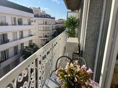 a balcony with a table and chairs on a balcony at CENTRAL CANNES in Cannes