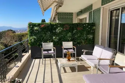 a patio with two chairs and a couch on a balcony at Sea View & Large Terrace LIVE IN LA VISTA in Cannes
