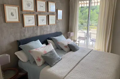 a bedroom with a bed with pillows and a window at Sea View & Large Terrace LIVE IN LA VISTA in Cannes