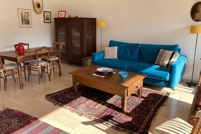 a living room with a blue couch and a table at Le Gallia haven of peace in the city center with Terrace GALLIA LYS in Cannes