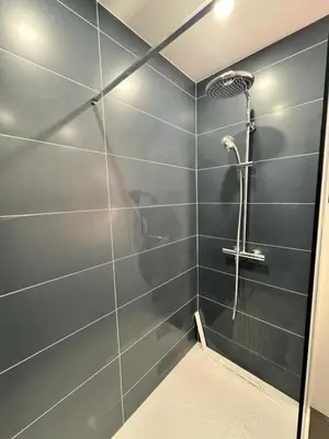 a bathroom with a shower with blue tiles at Le Gallia haven of peace in the city center with Terrace GALLIA LYS in Cannes