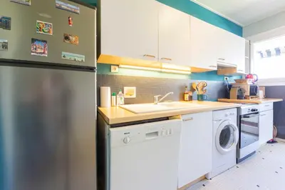 a kitchen with a washing machine and a sink at Le Gallia haven of peace in the city center with Terrace GALLIA LYS in Cannes