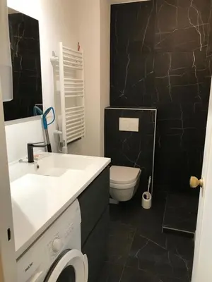 a bathroom with a white sink and a toilet at Design studio terrace and beach LIVE IN MARLYNE in Cannes