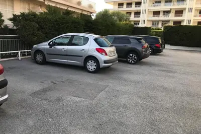 a row of parked cars in a parking lot at Design studio terrace and beach LIVE IN MARLYNE in Cannes