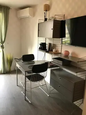 a kitchen with a table and chairs and a desk at Design studio terrace and beach LIVE IN MARLYNE in Cannes