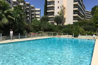 a large swimming pool in front of some buildings at WE CANNES ! Terrace sea view swimming pool car park Cannes Center in Cannes