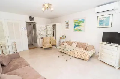 a living room with a couch and a tv at Cosy Studio Cannes Center beaches shopping and congresses LIVE IN MERLE in Cannes