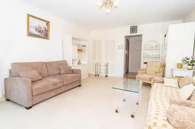 a living room with a couch and a glass table at Cosy Studio Cannes Center beaches shopping and congresses LIVE IN MERLE in Cannes