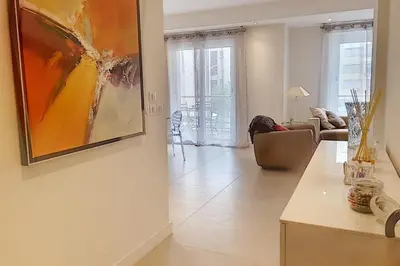 a living room with a painting on the wall at Sublime Apartment Center Croisette LIVE IN Moliere in Cannes