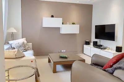 a living room with a couch and a tv at Sublime Apartment Center Croisette LIVE IN Moliere in Cannes