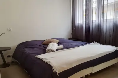 a unmade bed with a stuffed animal on it at Sublime Apartment Center Croisette LIVE IN Moliere in Cannes