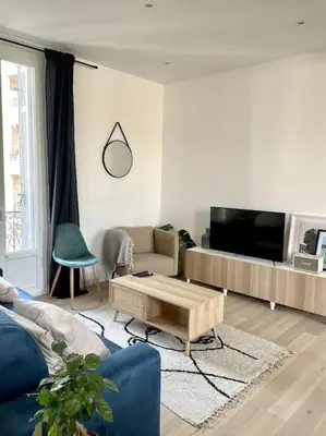 a living room with a couch and a coffee table at Superbe 2 pièces lumineux - Cannes Gare in Cannes