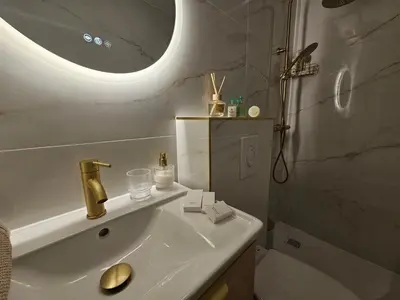 a bathroom with a sink and a shower with a mirror at Cannes suquet Croisette in Cannes
