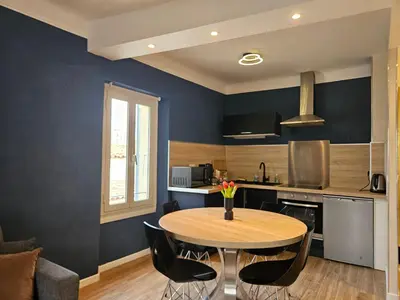 a kitchen with a table and chairs in a room at Cannes suquet Croisette in Cannes