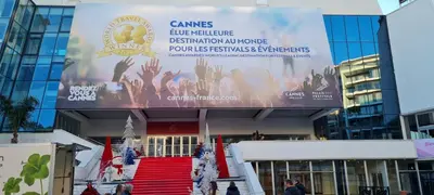 a large banner in front of a building with a red stairs at Cannes suquet Croisette in Cannes