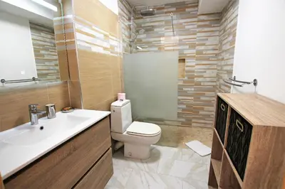 a bathroom with a white sink and a toilet at Appartement 80 m2 au centre-ville de Cannes in Cannes