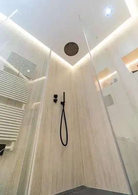 a shower in a room with a wooden floor at Palm croisette front de mer1 in Cannes