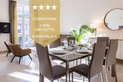 a dining room with a table with chairs and a mirror at 2-Br steps from the Palais des Festivals in Cannes