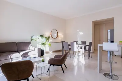 a living room with a couch and chairs and a table at 2-Br steps from the Palais des Festivals in Cannes