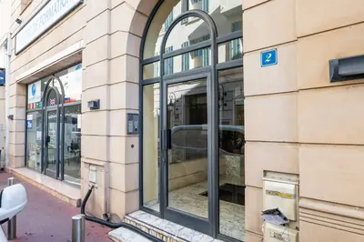 a row of windows on the side of a building at 2-Br steps from the Palais des Festivals in Cannes
