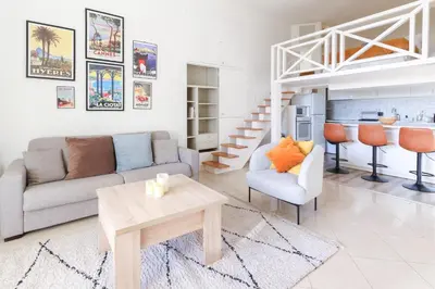 a living room with a couch and a table at Beautiful Renovated Studio with AC and TERRACE - Benakey in Cannes