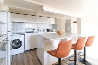 a kitchen with a counter and two bar stools at Beautiful Renovated Studio with AC and TERRACE - Benakey in Cannes