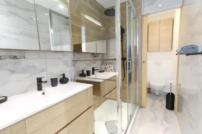 a bathroom with two sinks and a shower at Beautiful Renovated Studio with AC and TERRACE - Benakey in Cannes
