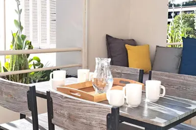 a table with a glass vase on top of it at Beautiful Renovated Studio with AC and TERRACE - Benakey in Cannes