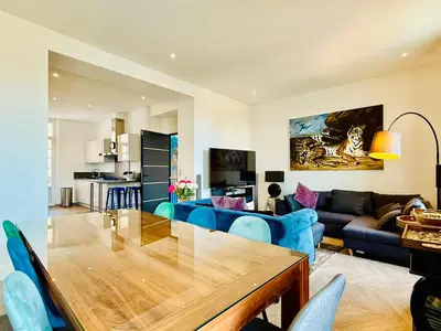 a living room with a blue couch and a table at Superbe Villa - Cannes Centre -Proche Palais des Festivals et Plages in Cannes