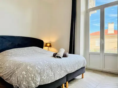 a bedroom with a bed and a large window at Superbe Villa - Cannes Centre -Proche Palais des Festivals et Plages in Cannes