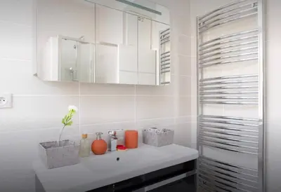 a bathroom with a white sink and a mirror at La Croisette in Cannes