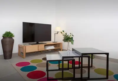 a living room with a television and a table at La Croisette in Cannes