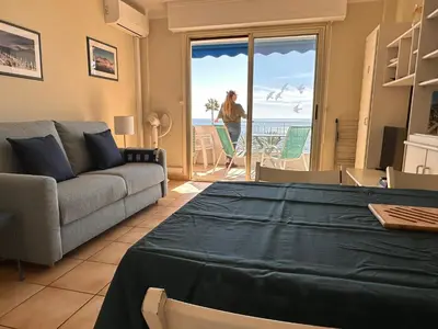 a living room with a couch and a view of the ocean at One bedroom apartment in Cannes with a balcony and great sea views - 821 in Cannes