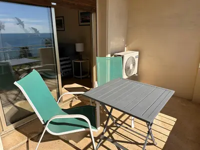 a table and a chair in a room with a balcony at One bedroom apartment in Cannes with a balcony and great sea views - 821 in Cannes