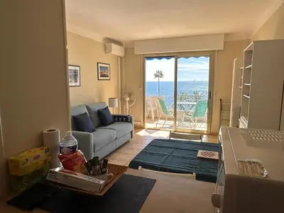 a living room with a couch and a view of the ocean at One bedroom apartment in Cannes with a balcony and great sea views - 821 in Cannes