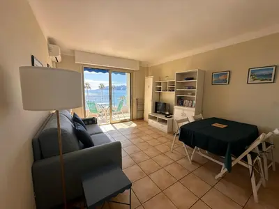 a living room with a couch and a table at One bedroom apartment in Cannes with a balcony and great sea views - 821 in Cannes