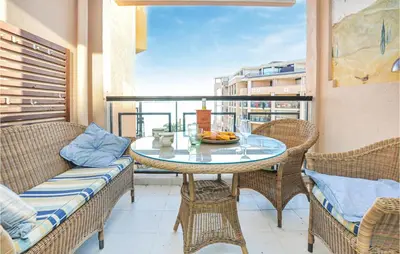 a balcony with a table and chairs and a window at 1 Bedroom Beautiful Apartment In Cannes in Cannes