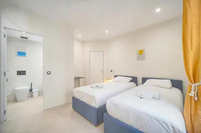 a bedroom with two beds and a bathroom at Moderne 2 chambres, CARRE D'OR- COEUR DE CANNES A2B194 in Cannes