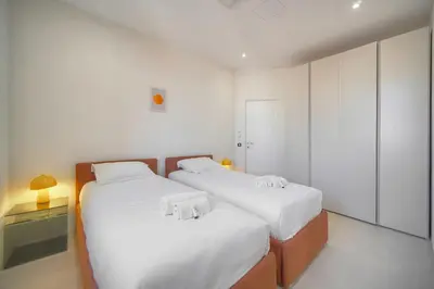 two beds in a room with white walls at Moderne 2 chambres, CARRE D'OR- COEUR DE CANNES A2B194 in Cannes