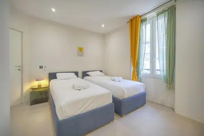 a bedroom with two beds and a window at Moderne 2 chambres, CARRE D'OR- COEUR DE CANNES A2B194 in Cannes