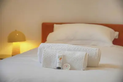 a pile of towels on a white bed at Moderne 2 chambres, CARRE D'OR- COEUR DE CANNES A2B194 in Cannes