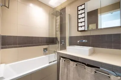 a bathroom with a sink and a tub and a mirror at Agence des Résidences - Plein centre de Cannes in Cannes