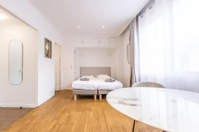 a bedroom with a bed and a glass table at Agence des Résidences - Plein centre de Cannes in Cannes