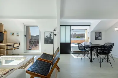 a living room with a table and chairs at Agence des Résidences - Plein centre de Cannes in Cannes
