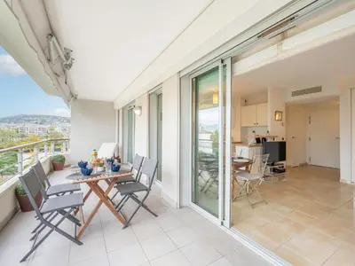a patio with a table and chairs on a balcony at Apartment Cristal Croisette-4 by Interhome in Cannes