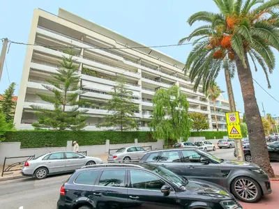 a parking lot with cars parked in front of a large building at Apartment Cristal Croisette-4 by Interhome in Cannes